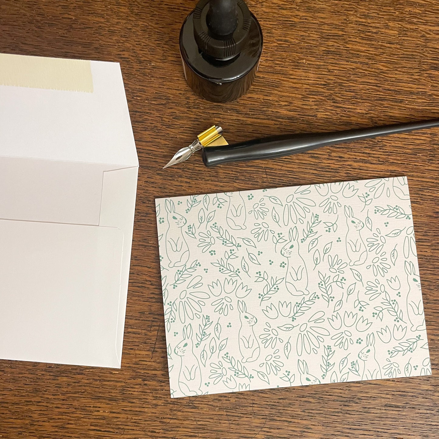 Photo of card with envelope and fountain pen and ink.