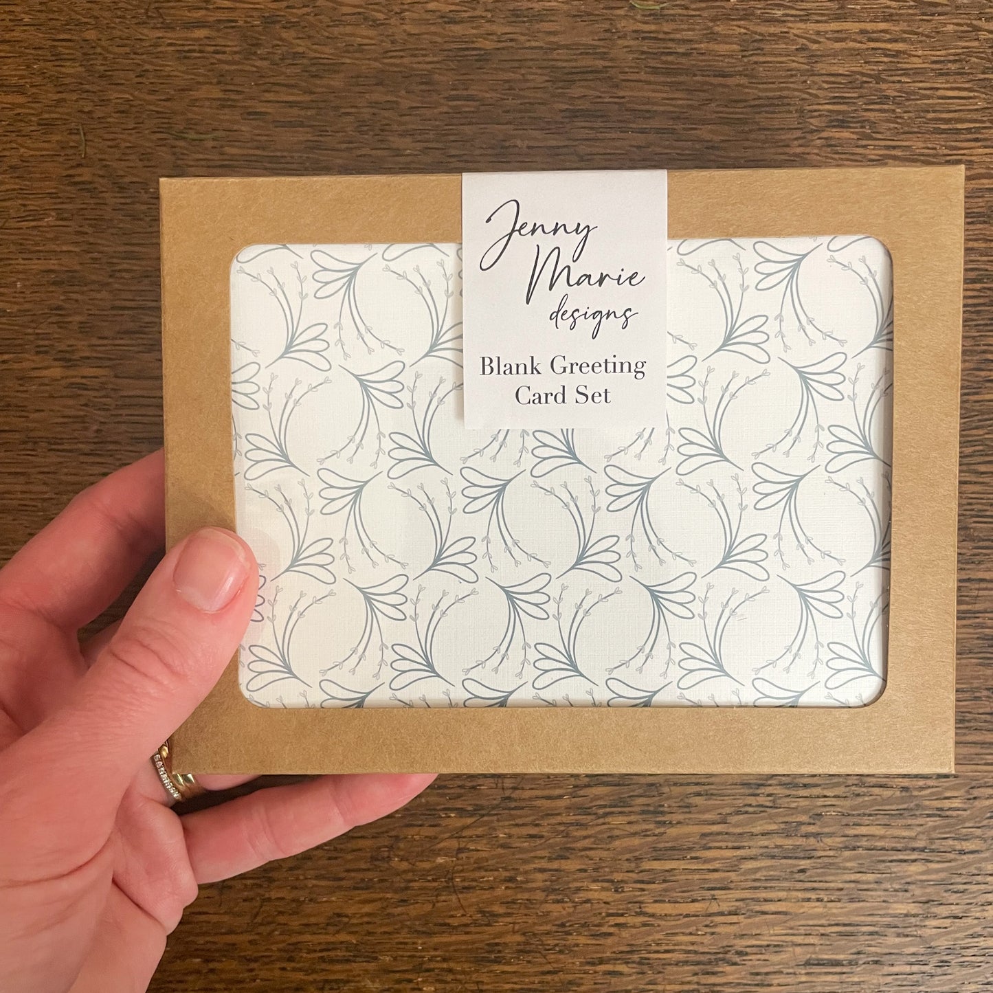 Photo of greeting card set retail packaging being held in hand.