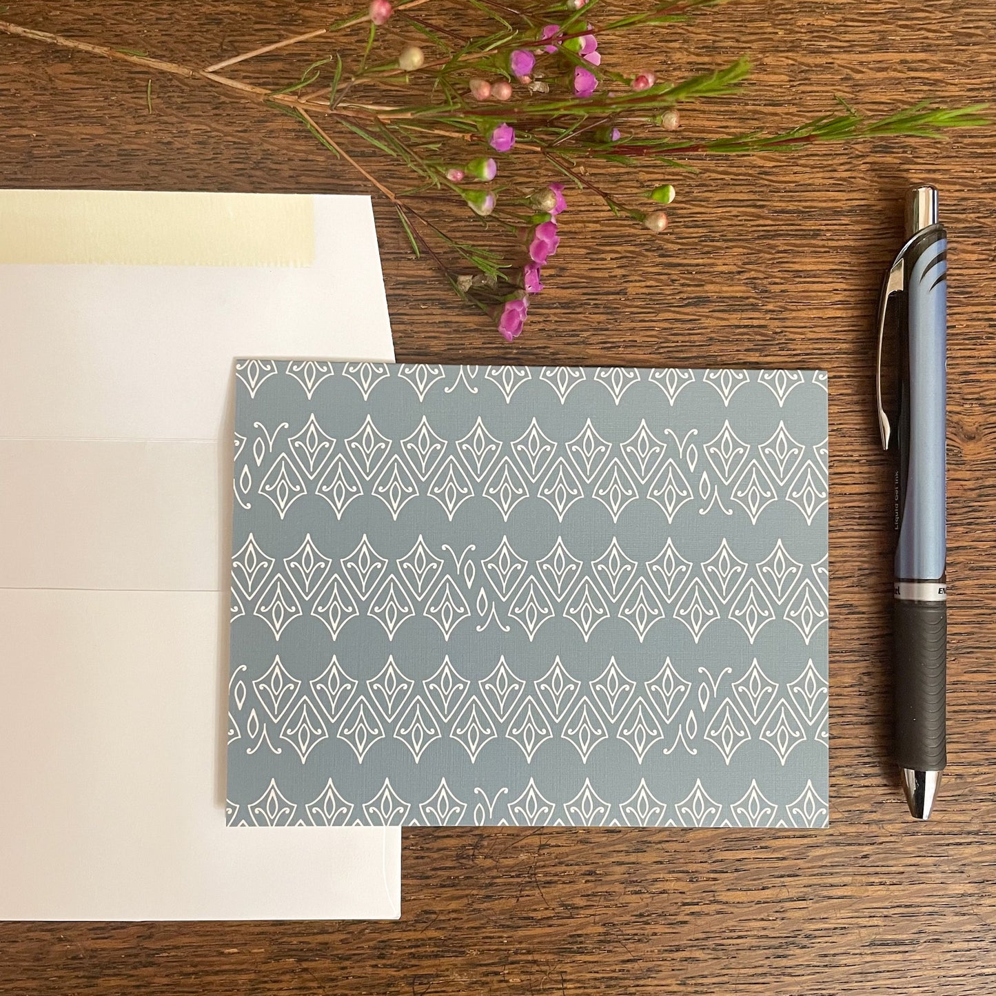 Photo of greeting card with envelope and pen.